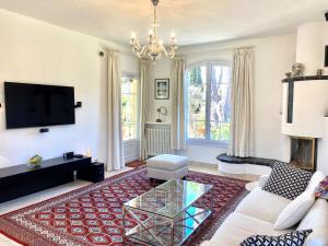 a living room with a couch and a coffee table at VILLA LES ONDES VI4120 in Juan-les-Pins