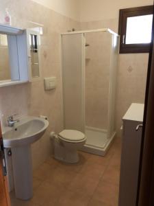 a bathroom with a shower and a toilet and a sink at Lito’s house in Villasimius in Villasimius +10 photos