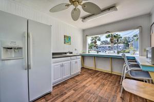 a kitchen with a refrigerator and a dining table at St Simons Condo with Resort Amenities 1 Mi to Beach in Mallory Park