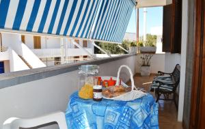 a table with food on it on a balcony at Casa vacanza vicino spiaggia-ll23 in San Foca