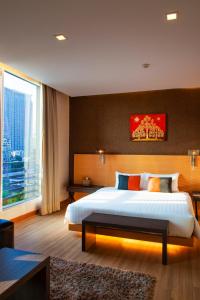 a bedroom with a large bed and a large window at Hotel Solo, Sukhumvit 2, Bangkok - SHA Extra Plus in Bangkok