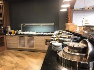 a kitchen with many pots and pans on a counter at Hotel Boursier 2 & Spa in Istanbul