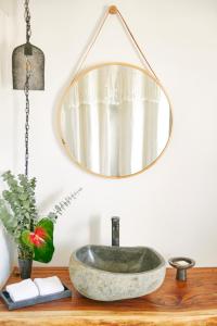a bathroom sink with a mirror on a wooden counter at Hero Beach Club in Montauk +63 photos