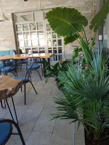 a patio with tables and plants in a restaurant at Hostel Mornar in Velika Kladuša