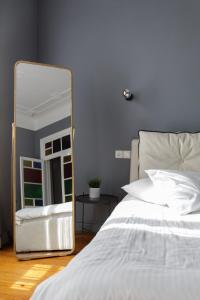 una camera da letto con specchio accanto a un letto di Soho Apartments ad Atene