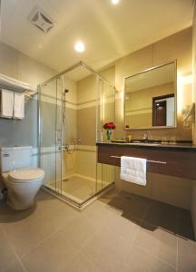 a bathroom with a shower and a toilet and a sink at F Hotel - Hualien in Hualien City