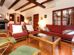 Sala de estar con sofás rojos y mesa de centro en Holiday Home La Plaza by Interhome, en Calonge