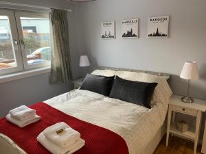 a bedroom with a bed with towels on it at Flat One, 212 Eaglesham Road, East Kilbride, Glasgow in Glasgow