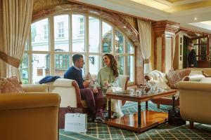 a man and a woman sitting in a room at Killarney Plaza Hotel & Spa in Killarney