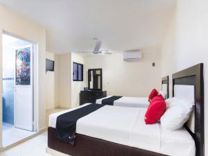 Cama ou camas em um quarto em Hotel Jardín Cancún