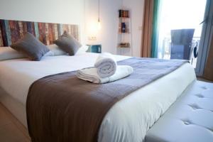 a hotel room with two beds with a towel at Mataro Luxury Apartments in Mataró