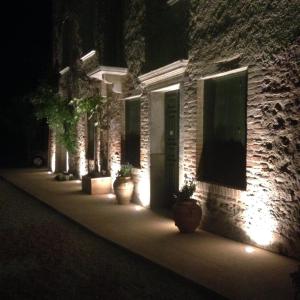 a building with lights on the side of it at night at Appartamenti Quota 101 in Arqua Petrarca