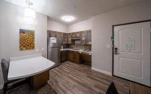 a kitchen with a white door and a refrigerator at Staybridge Suites Houston East - Baytown, an IHG Hotel in Baytown