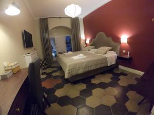 a bedroom with a bed and a dresser at Residenza Roma Imperiale in Rome