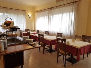 a dining room with tables and chairs and a window at Hotel Patrizia in Marina di Massa