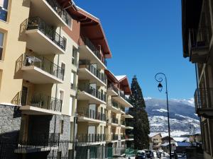 a tall building with balconies on a street at Les Campanules in Bourg-Saint-Maurice