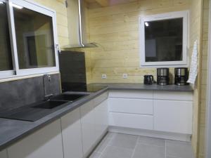 a kitchen with white cabinets and a sink and a window at Domaine Du Sauveur in Luz-Saint-Sauveur