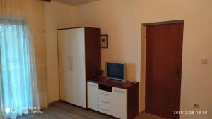 Zimmer mit einer Kommode, einem TV und einem Schrank in der Unterkunft Studio apartment Marčelina in Preko