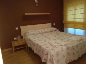 ein Schlafzimmer mit einem Bett mit zwei Handtüchern darauf in der Unterkunft El Patio in Saragossa