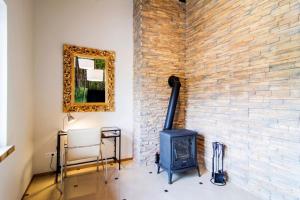 a fireplace in a room with a brick wall at Apartament Platinum 1 in Ustroń