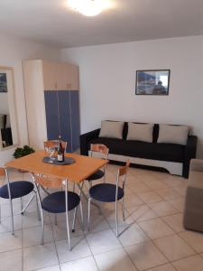 a living room with a table and chairs and a couch at House Vida Goraleks in Baška Voda