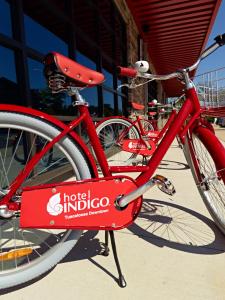 a red bike parked next to a red fire hydrant at Hotel Indigo Tuscaloosa Downtown, an IHG Hotel in Tuscaloosa