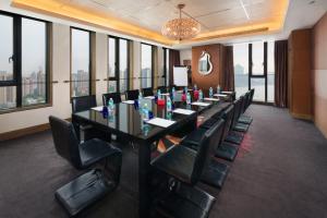 a conference room with a long table and chairs at Hotel Indigo Shanghai On The Bund, an IHG Hotel in Shanghai