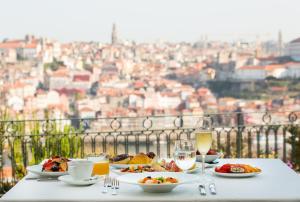 a table with plates of food and glasses of wine at The Yeatman in Vila Nova de Gaia