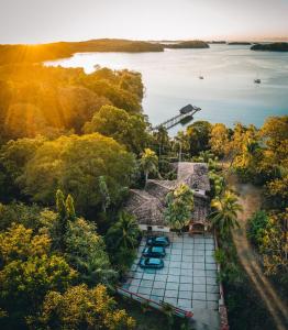 an aerial view of a villa on the water with trees at Seagull Cove Resort in Boca Chica