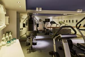 a gym with treadmills and machines in a room at Hotel Indigo Berlin – Ku’damm, an IHG Hotel in Berlin