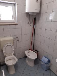 a bathroom with a toilet and a sink at House Vida Goraleks in Baška Voda