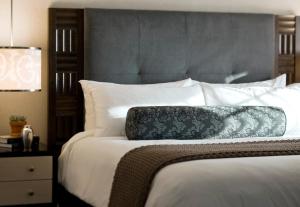 a bed with a black and white pillow on it at Forty 1 North in Newport +17 photos