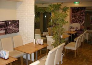 a restaurant with wooden tables and white chairs at Azu garden Nippombashi / Vacation STAY 74144 in Osaka