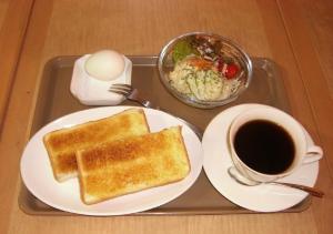 a tray with two slices of toast and a cup of coffee at Azu garden Nippombashi / Vacation STAY 74141 in Osaka