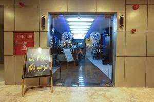 a store with a sign in front of a glass door at Raoum Inn - Hawtah Bani Tamim in Hotat bani tamim