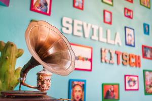 a lamp that is on top of a wall at Sevilla Kitsch Hostel Art in Seville