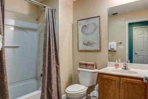 a bathroom with a toilet and a sink and a shower at Sterling Reef 2 in Panama City Beach