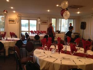 a banquet room with tables with red napkins and balloons at Pinnacles Edge Resort in Cervantes +22 photos