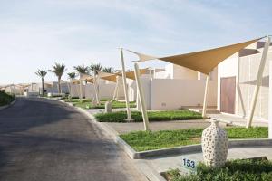 a street with a row of houses and a road at Park Inn by Radisson Hotel and Residence Duqm in Duqm