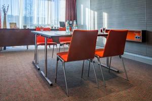 a conference room with a table and chairs at Radisson Blu Hotel Köln in Cologne