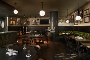 a restaurant with tables and chairs and a bar at Fitler Club in Philadelphia