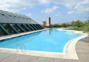 a large swimming pool in front of a building at Apartment in Bursa - Turkey in Bursa