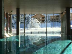 a house with a swimming pool in the snow at Pradas Resort Brigels in Brigels