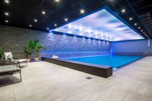 a swimming pool in a building with a large aquarium at Radisson Blu Scandinavia Hotel, Oslo in Oslo