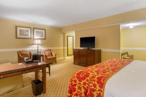 a hotel room with a bed and a desk and a tv at Boston Omni Parker House Hotel in Boston