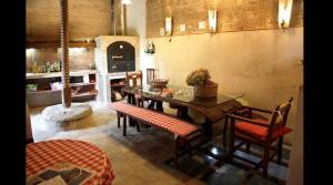 a room with a table and chairs and a kitchen at La Pequeña A y B in Villaherreros