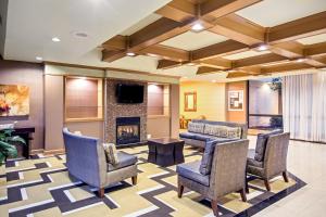 a lobby with chairs and a fireplace at Holiday Inn Roanoke - Tanglewood Route 419 & I 581, an IHG Hotel in Roanoke