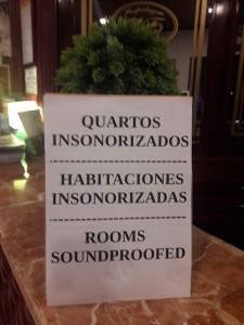 a sign on a counter with a potted plant at VILA FORMOSA AL-Estabelecimento de Hospedagem,Quartos-Rooms in Monte Gordo