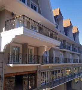 a building with balconies on the side of it at Hotel Daara in Gramado