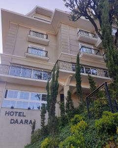 a hotel daarra building with trees in front of it at Hotel Daara in Gramado